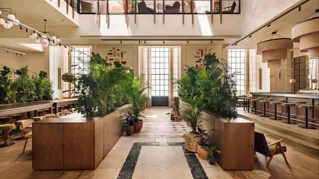 Biophilic event space with natural dividers for networking receptions and corporate breakout sessions.