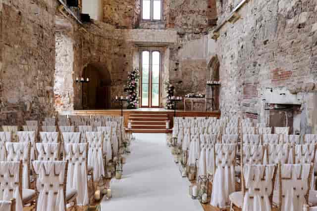 Historic stone venue with elegant ceremony seating for luxury weddings and corporate events.