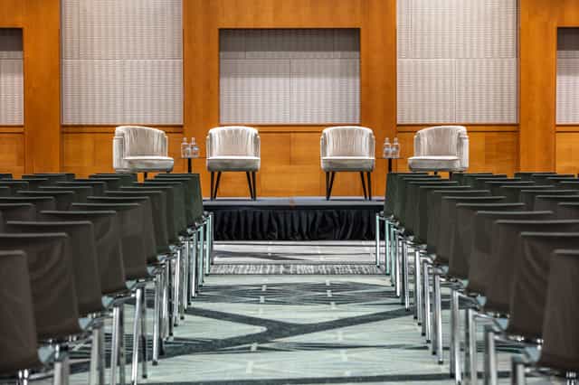 Antwerp hotel event stage, panel discussion, presentation.