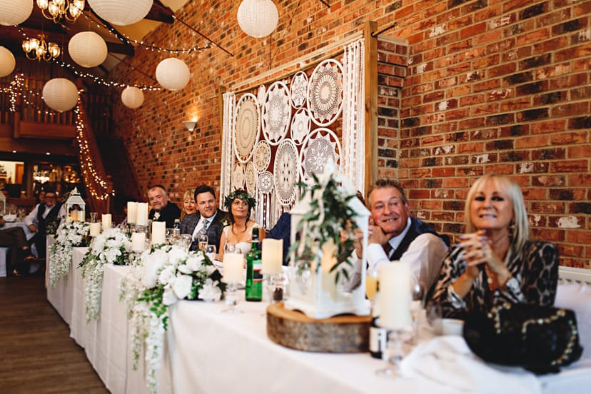 Wedding head table: macrame, florals, Ellis Suite