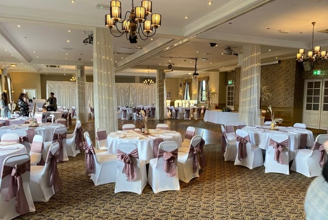 Wedding reception venue, elegant table setting, string lights