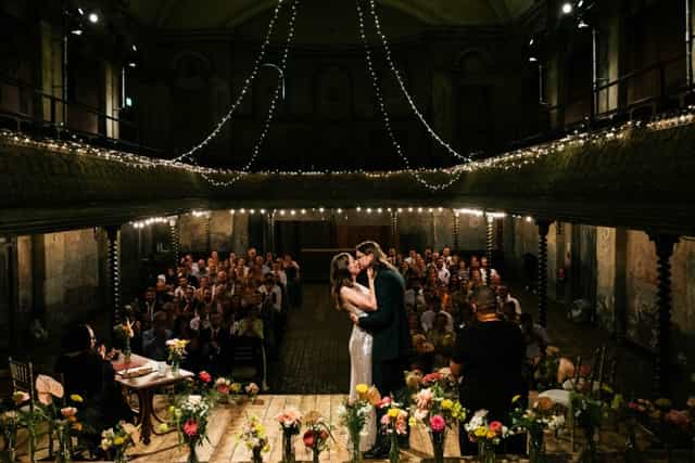 Intimate heritage wedding ceremony, fairy lights, florals, banqueting hall event.