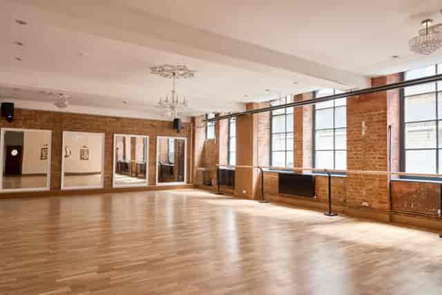 Industrial-chic studio space with exposed brick for creative workshops and wellness retreats.