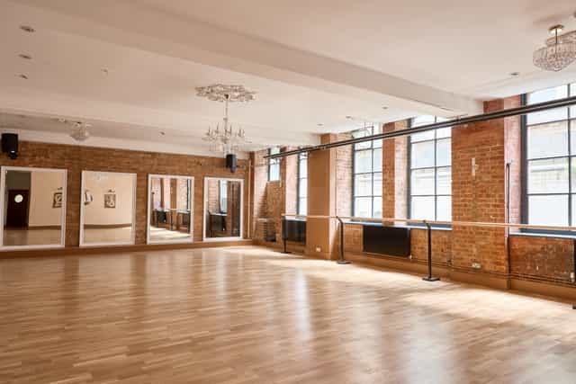Industrial-chic studio space with exposed brick for creative workshops and wellness retreats.