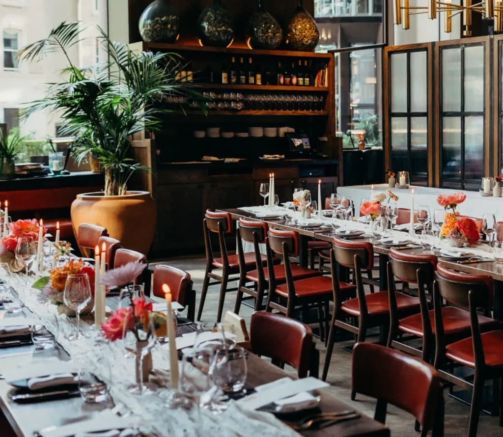 Mezzanine Vinoteca event: elegant long table, floral decor, reception setup