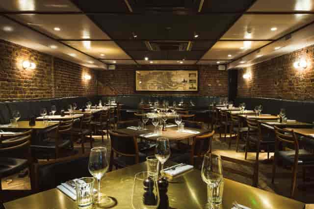 Vesta Tilley Room with rustic brick walls for private corporate dinners and networking events.