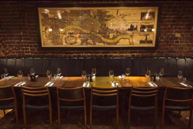 Vesta Tilley Room: Private corporate dining space with brick walls for networking events.