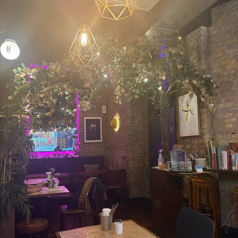 Biophilic Italian cafe dining room, brick, plants, event venue