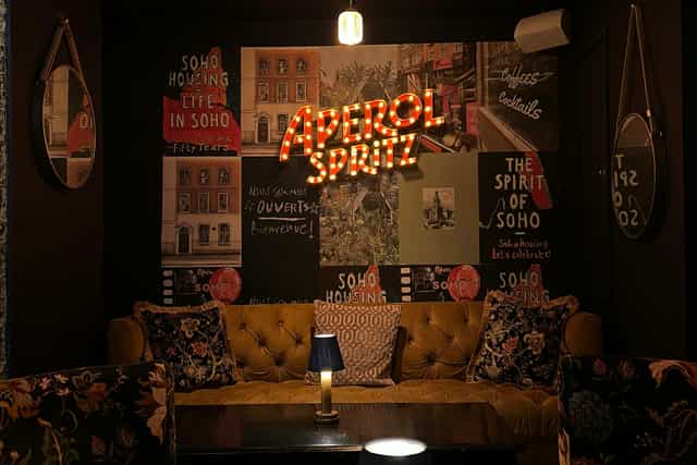 Chic Baaria bar with Aperol Spritz sign. Italian cafe reception, networking event.