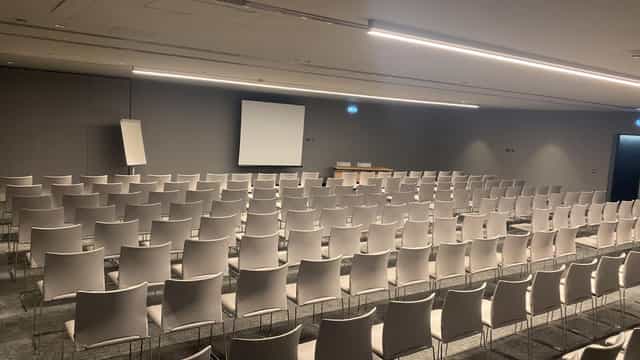 Theater-style ballroom at Hilton Porto Gaia featuring modern lighting for corporate conferences.