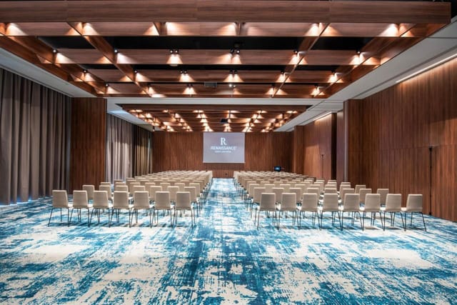 Theater-style ballroom at Renaissance Porto Lapa Hotel with wood accents for corporate events.