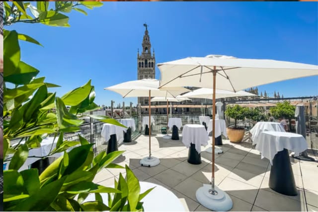 Rooftop cocktail reception at Hotel EME Seville with iconic cathedral backdrop for corporate events.