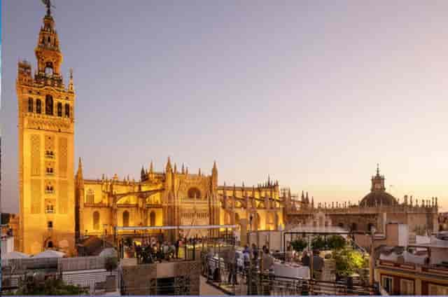 Rooftop event space at Hotel EME Catedral with Seville Cathedral view for corporate networking.