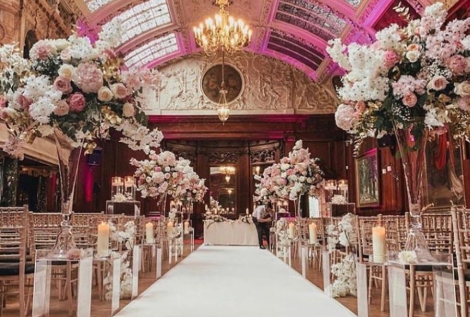 Luxury Garden Room wedding ceremony with floral decor at Thornton Manor Country Estate venue. - Banner