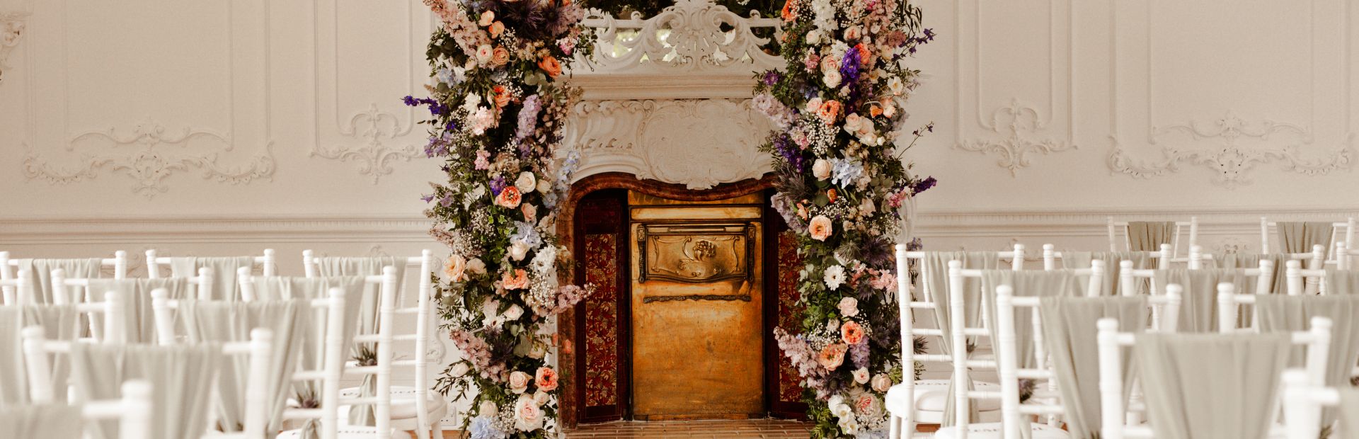 Floral fireplace decor at Edinburgh Zoo wedding venue, ideal for indoor ceremony photography.