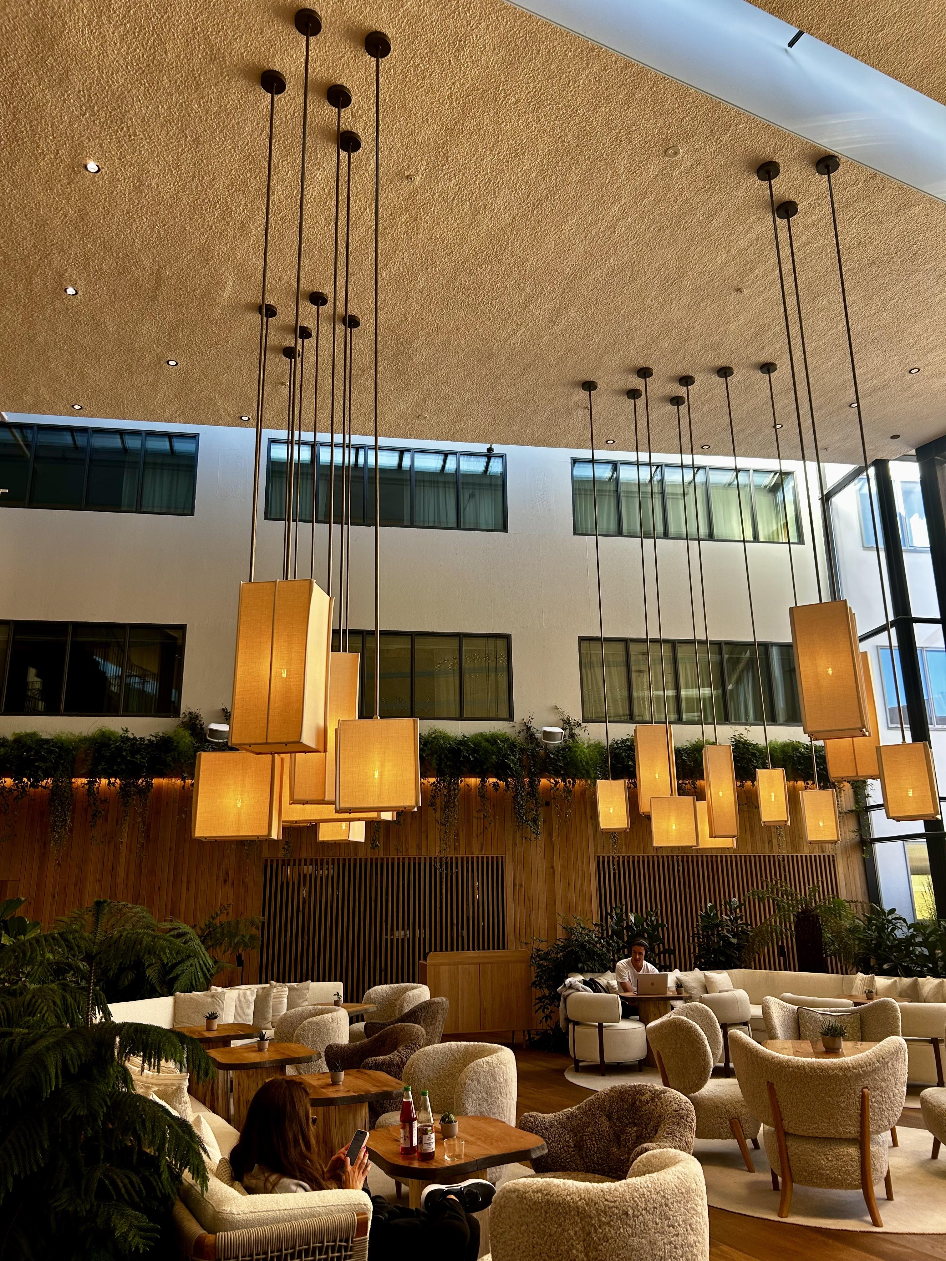 The Leaf Room at CR1 Bar & Lounge: modern high-ceilinged atrium for networking events.