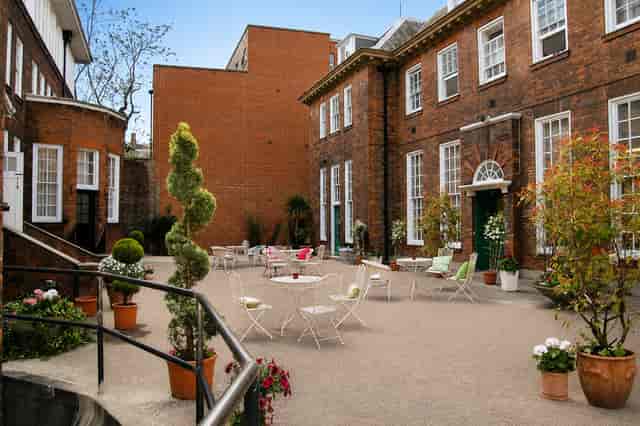Historic courtyard garden with bistro seating for networking events and receptions.