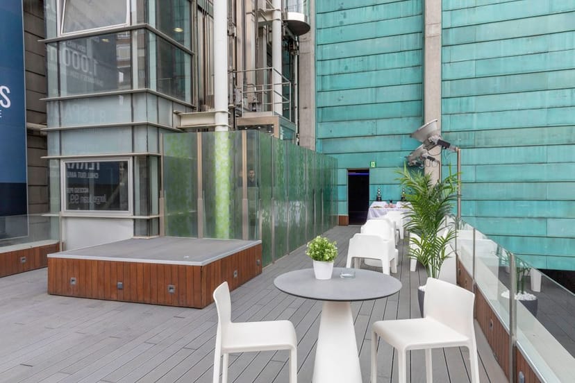 Truss Madrid rooftop event space with stage for networking receptions and corporate branding.