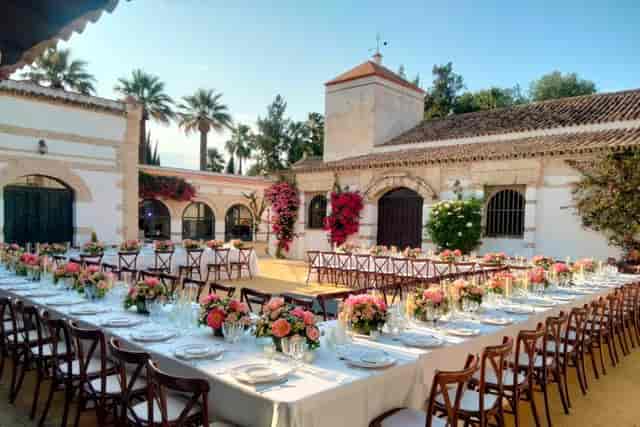 Patio de los Limoneros Mediterranean wedding reception with U-shaped banquet seating.