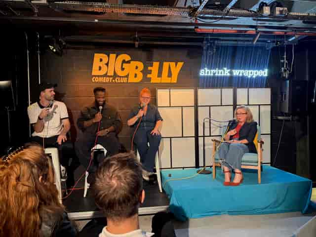 Big Belly Room stage setup with panel seating for comedy club events and live talk shows.