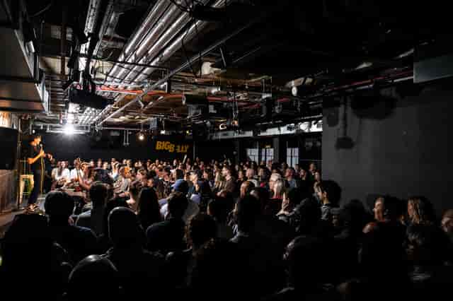 Big Belly Room theater-style setup with industrial lighting for intimate comedy club events.