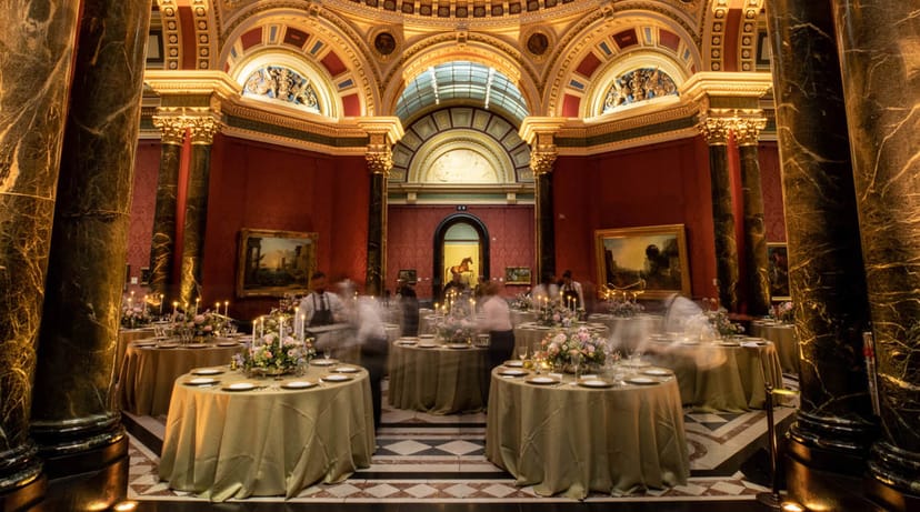 High-end gala setup in historic gallery with ambient lighting for luxury corporate event.