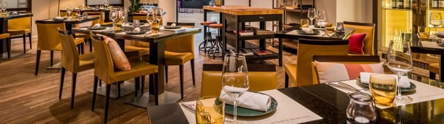 Modern restaurant interior at The Grapeful Vinotek, Munich; perfect for corporate networking events.