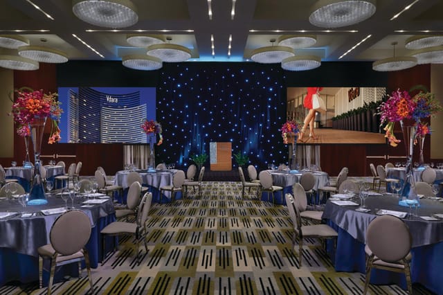 Viñoly Grand Ballroom gala dinner with star-drape backdrop, perfect for corporate event venue.