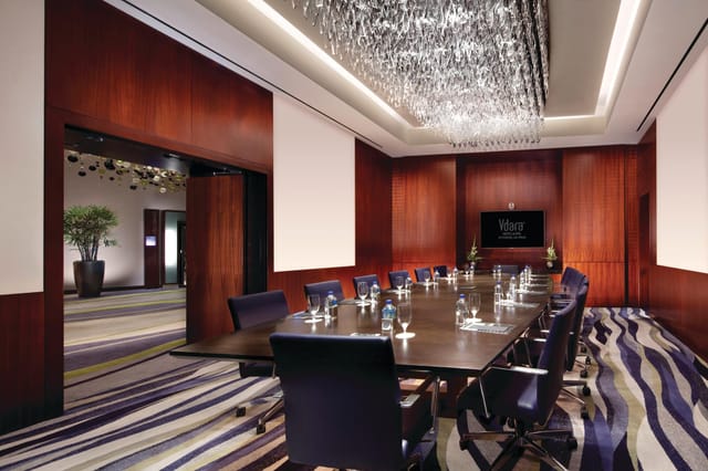 Executive boardroom at Vdara Las Vegas with crystal chandelier for luxury business meetings.