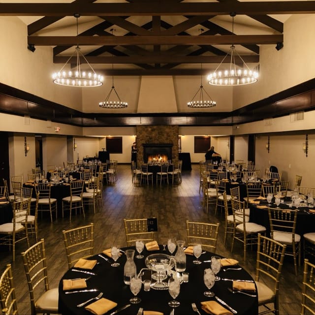 Ballroom with chandelier and fireplace for gala dinner or corporate event.
