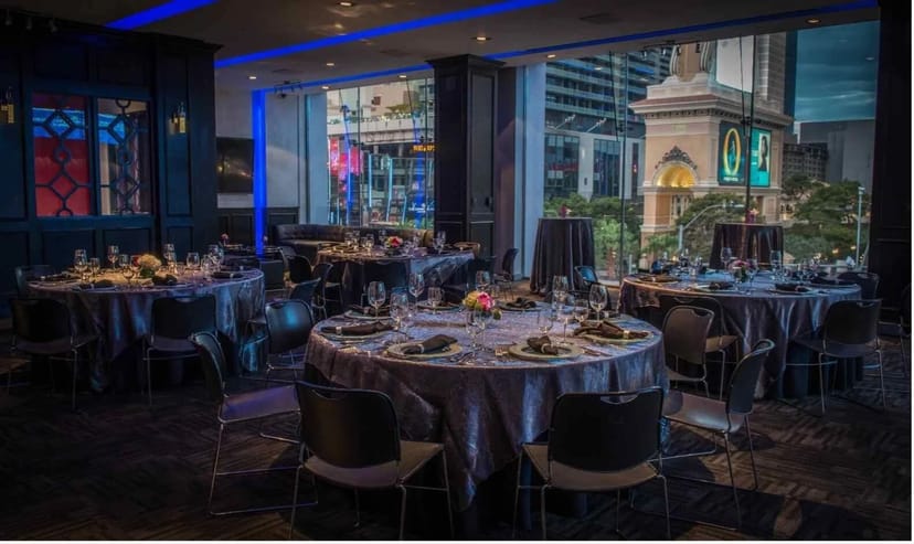 Main Hall banquet setup with floor-to-ceiling windows for corporate dinner and evening receptions.