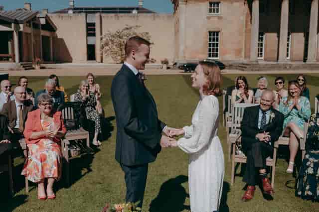 Outdoor wedding at Downing College Fellows' Garden with theater-style seating for ceremonies.