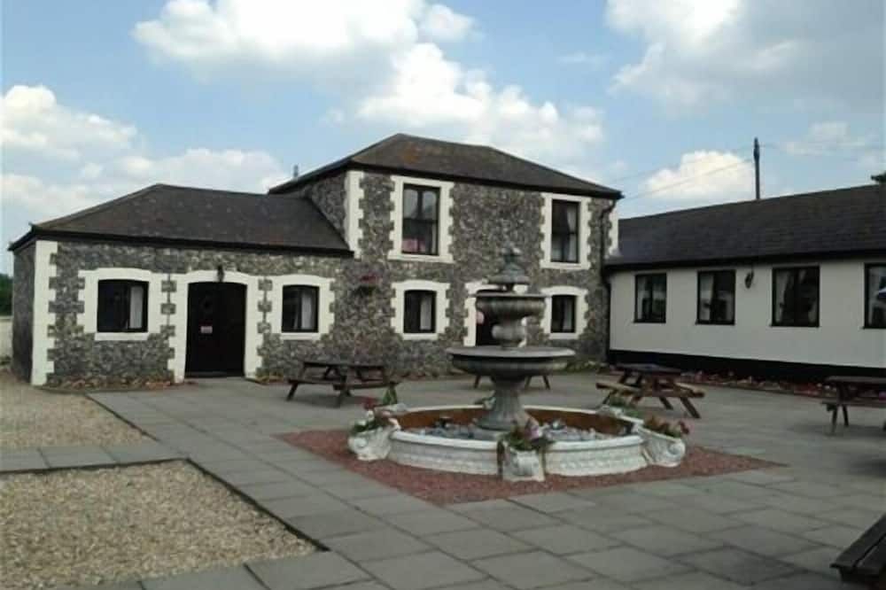 Rustic-chic outdoor breakout area at The Coach House Hotel for networking and team-building events.