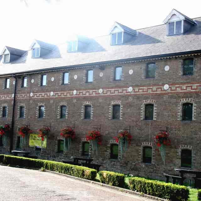 Historic Maltings venue for corporate retreats and rustic events with spacious brick exterior.