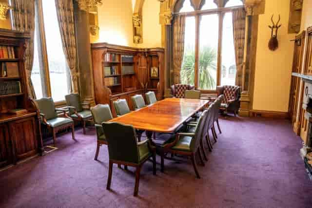 Historic boardroom with upscale decor for private strategy meetings and professional interviews.