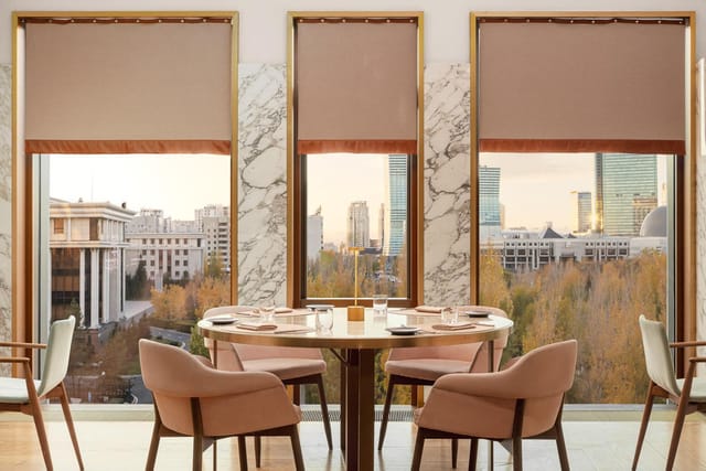 VIP Room at The Ritz-Carlton Astana with cityscape views for executive meetings and fine dining.