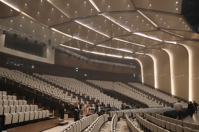 Modern Astana Congress Center auditorium with tiered seating for large-scale plenary conferences.