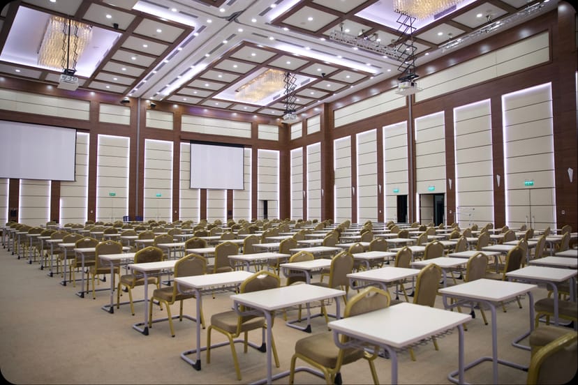 Main Hall ballroom at Nazarbayev University with dual screens for corporate training or conferences.