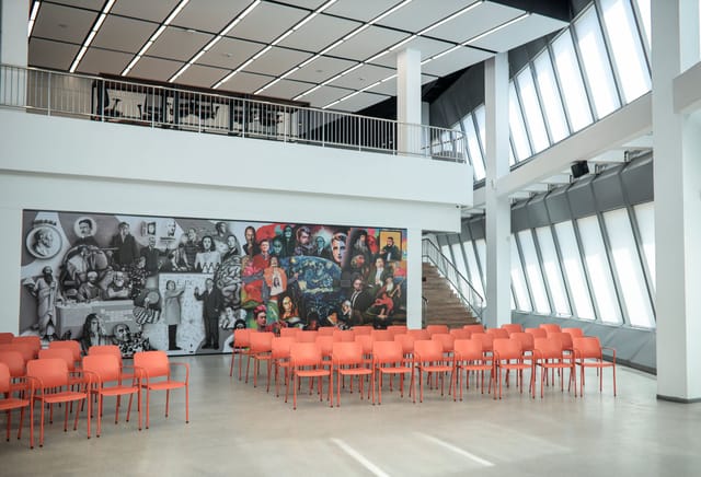 Blue Hall event venue, Nazarbayev University, featuring a dramatic mural for corporate conferences.