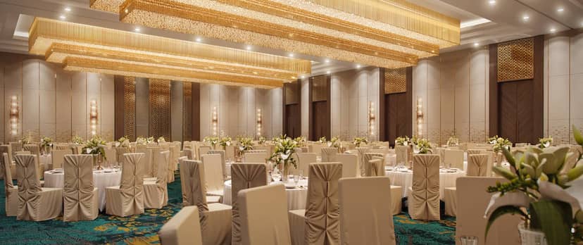King Hotel Astana ballroom with gold lighting for corporate galas and luxury weddings.