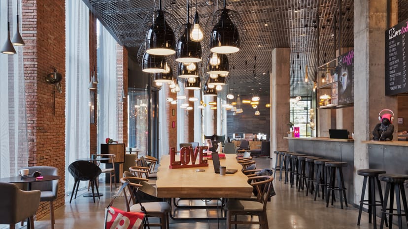 Moxy Tbilisi Auditoria: Industrial communal table for creative workshops and networking events.