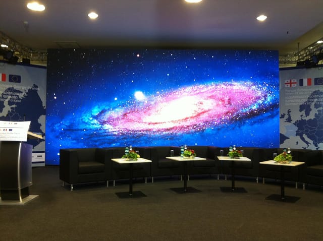 LED stage and lounge in Hall 11 ExpoGeorgia for professional panel discussions and tech events.