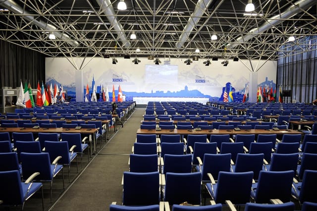 ExpoGeorgia Hall 3 classroom conference setup with national flags and stage.