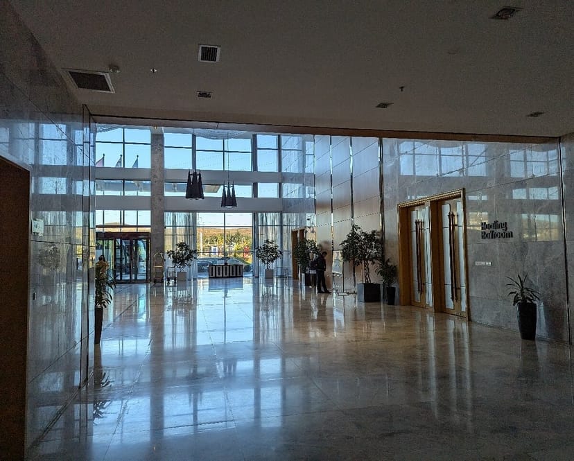 Hualing Tbilisi ballroom foyer with marble finishes for corporate events and professional meetings.