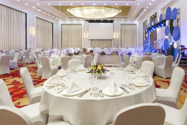 Hualing Ballroom gala dinner setup with professional stage for corporate events and weddings.