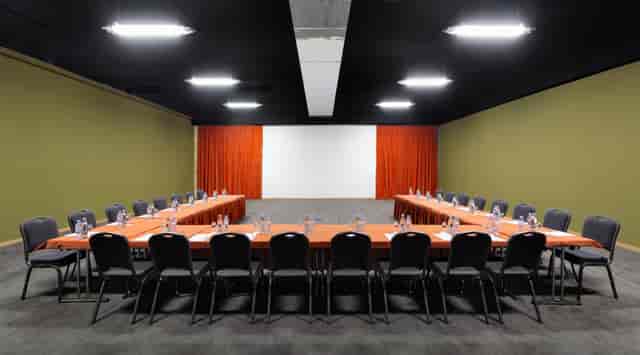 U-shape boardroom at Holiday Inn Tbilisi with orange linens for strategy meetings and events.