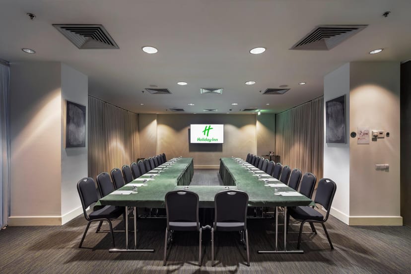 U-shape boardroom at Holiday Inn Tbilisi with wall monitor for corporate workshops and meetings.