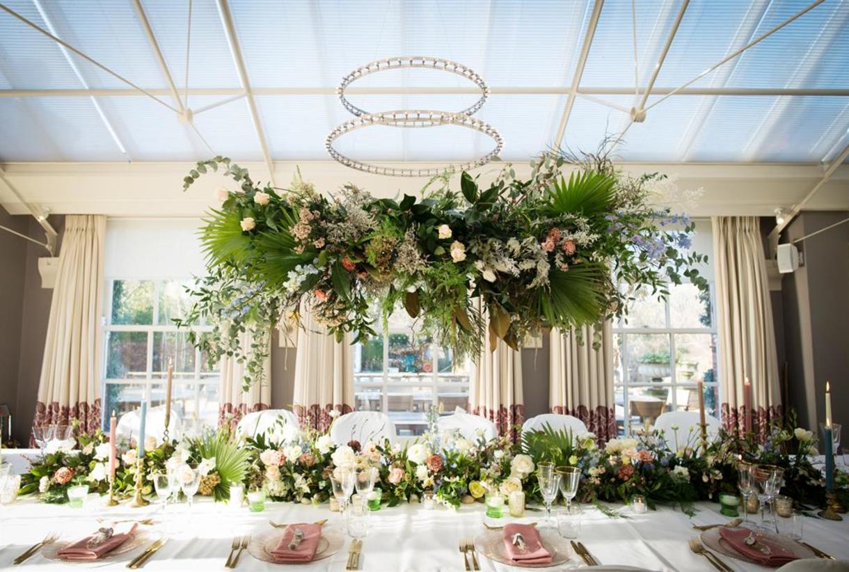 Floral tablescape in Lake Suite, Chewton Glen: elegant wedding dinner and luxury gala venue setup.