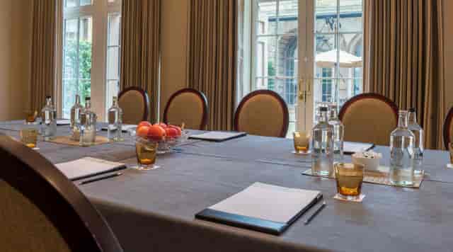 Boardroom setup at Motor House Cliveden, elegant corporate meeting venue with natural light.