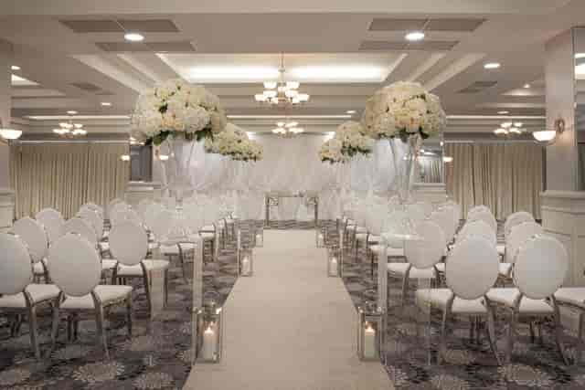 The Grand Ballroom at Crowne Plaza Belfast, wedding ceremony setup with elegant floral decor.